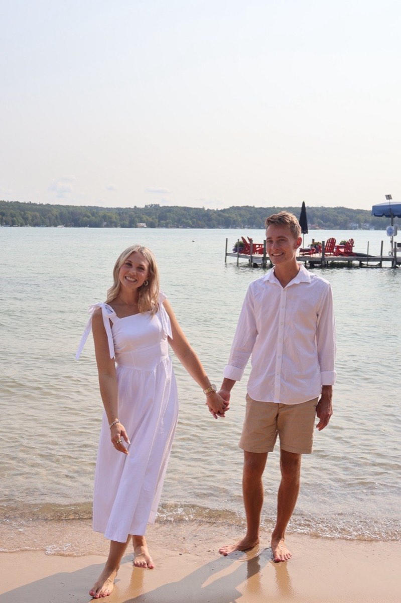 Tucker and Syd standing hand in hand at the water’s edge
