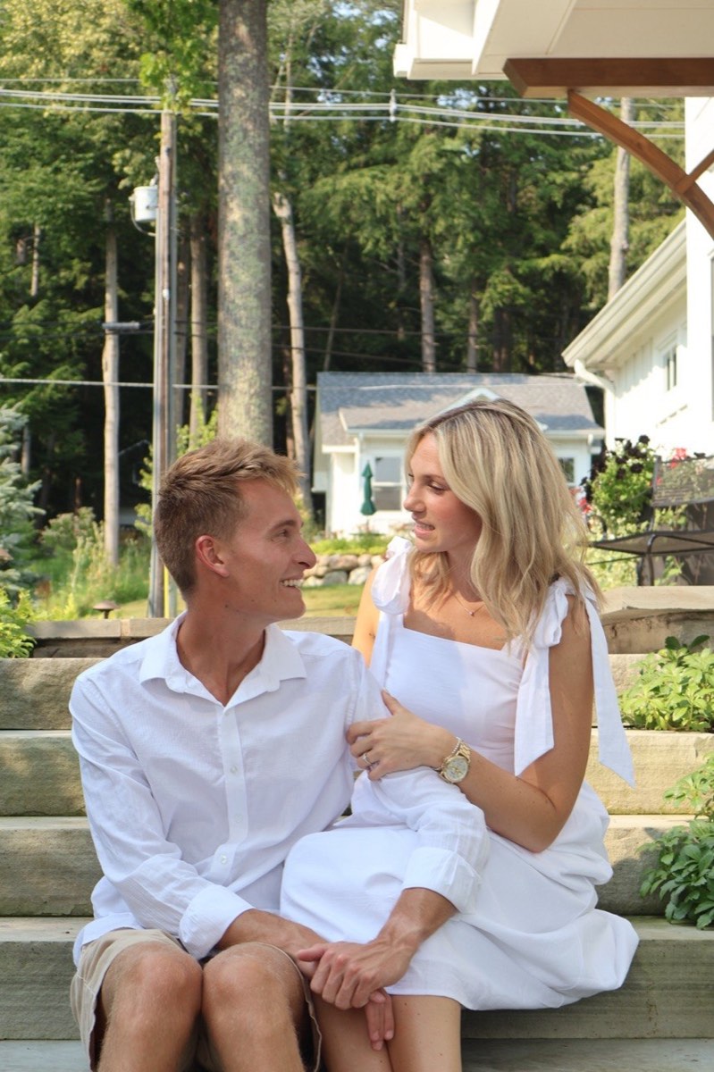 Tucker and Syd sharing a warm look while seated on garden steps